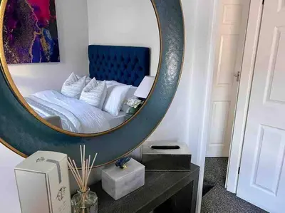 a bedroom with a bed with a large mirror at 2 Bed Newly Furbished Whole House sleeps 4 in Liverpool