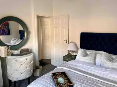 a bedroom with a large bed and a mirror at 2 Bed Newly Furbished Whole House sleeps 4 in Liverpool