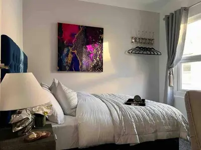 a bedroom with a bed and a painting on the wall at 2 Bed Newly Furbished Whole House sleeps 4 in Liverpool
