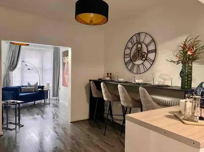 a kitchen and living room with a table and chairs at 2 Bed Newly Furbished Whole House sleeps 4 in Liverpool