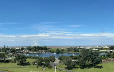 a park with a lake and a ferris wheel in the background at Royal Clifton Hotel in Southport