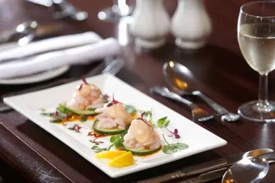 a plate of food with shrimp on a table at Royal Clifton Hotel in Southport