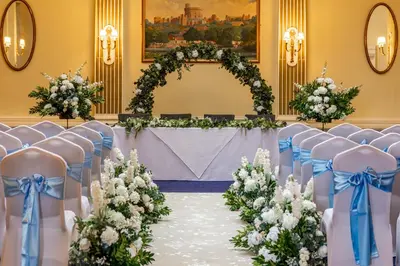 an aisle with chairs and a table with flowers at Royal Clifton Hotel in Southport