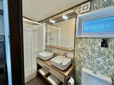 a bathroom with two sinks and a shower at Luxury Langham Lodge in Clitheroe