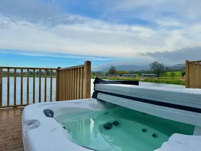 a hot tub with snow on top of a deck at Luxury Langham Lodge in Clitheroe