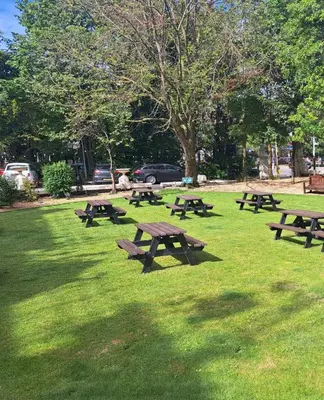 a group of picnic tables in a park at Prince Of Wales Hotel in Southport