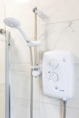 a shower with a shower head in a bathroom at Flatzy - Modern 3 Bedroom Home in City Centre in Liverpool