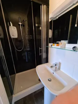 a bathroom with a sink and a shower at The Penkelie in Southport