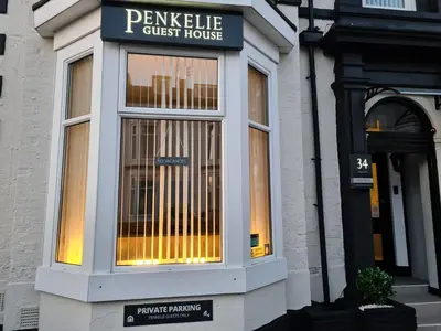 a storefront window of a guest house on a street at The Penkelie in Southport