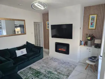 a living room with a couch and a fireplace at The Bay Cottage Hot Tub & Sauna Morecambe Bay in Morecambe
