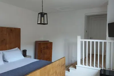 a bedroom with a bed and a tv on the wall at Large 2 Bedroom City Centre Apartment + Parking in Preston