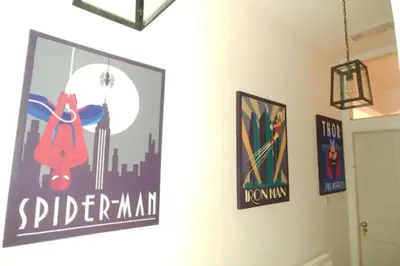 a room with posters on the wall and a door at Large 2 Bedroom City Centre Apartment + Parking in Preston