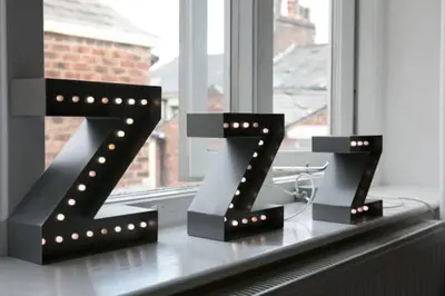 two lights in the shape of z on a window sill at Large 2 Bedroom City Centre Apartment + Parking in Preston