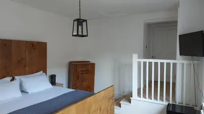 a bedroom with a bed and a flat screen tv at Superking Size City Centre En-Suite Room + Parking in Preston