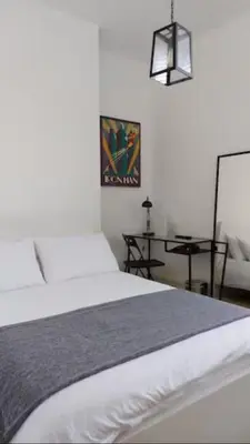 a bedroom with a white bed and a table at Stylish Double Room in City Centre - Shared Bathroom - Parking in Preston