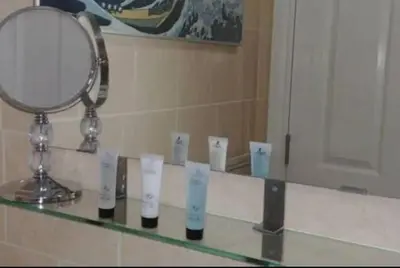 a mirror sitting on top of a counter in a bathroom at Stylish Double Room in City Centre - Shared Bathroom - Parking in Preston