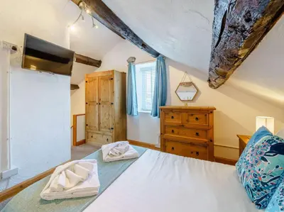 a bedroom with a bed and a wooden dresser at 3 Bed in Grange-over-sands oc-83368 in Cartmel