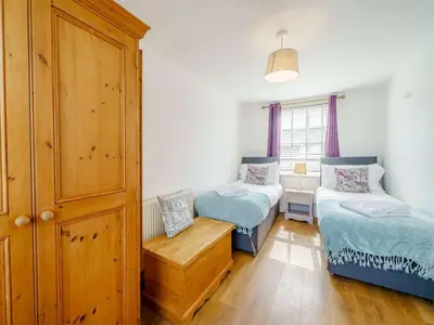 a room with two beds and a bench in it at 3 Bed in Grange-over-sands oc-83368 in Cartmel