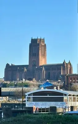a large building with a large boat in front of it at Entire Town House In Liverpool Marina in Liverpool