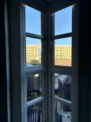 an open window with a view of a building at Entire Town House In Liverpool Marina in Liverpool