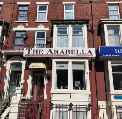 a red brick building with a sign for the arabia at The Arabella in Blackpool