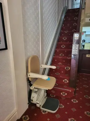 a stair lift chair sitting on the floor next to a staircase at The Arabella in Blackpool