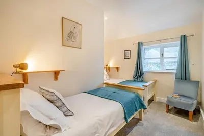 a bedroom with a bed and a desk and a chair at 2 Bed in Ulverston oc-sz013 in Haverthwaite