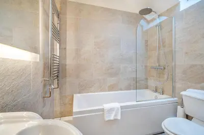 a bathroom with a tub and a toilet and a sink at 2 Bed in Ulverston oc-sz013 in Haverthwaite