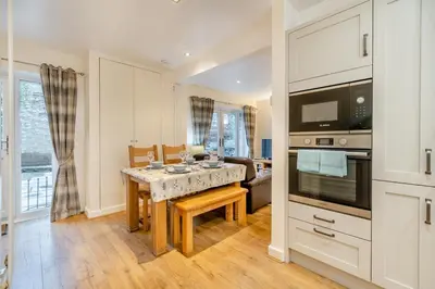 a kitchen with a table and a dining room at 2 Bed in Ulverston oc-sz013 in Haverthwaite