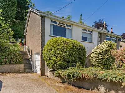 a house with a white door and some bushes at 3 Bed in Carnforth oc-sz425 in Arnside