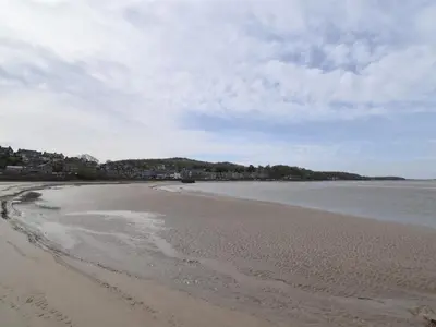 an empty beach with footprints in the sand at 3 Bed in Carnforth oc-sz425 in Arnside