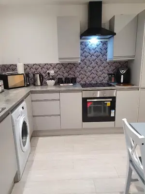 a kitchen with a stove and a washing machine at Blackpool Central Beach Apartments in Blackpool
