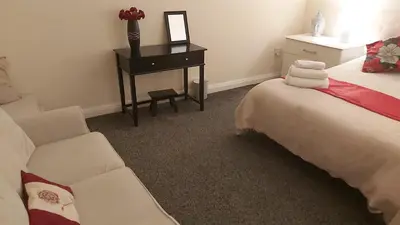 a bedroom with a bed and a desk and a chair at Blackpool Central Beach Apartments in Blackpool