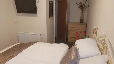 a bedroom with a bed and a tv and a dresser at Blackpool Central Beach Apartments in Blackpool