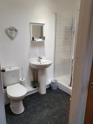 a bathroom with a toilet and a sink and a shower at Blackpool Central Beach Apartments in Blackpool