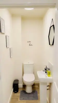 a bathroom with a toilet and a sink at Mo Apartment in Accrington