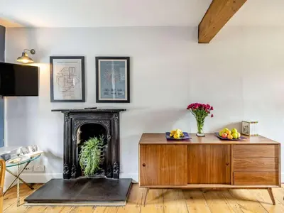 a living room with a table and a fireplace at 3 Bed in Ulverston oc-87960 in Greenodd