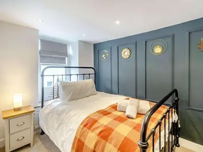 a bedroom with a bed and blue walls at 3 Bed in Ulverston oc-87960 in Greenodd