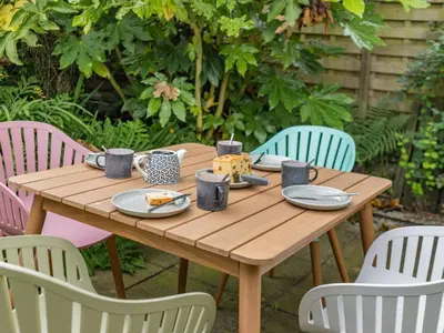 a wooden table with plates of food on it at 3 Bed in Ulverston oc-87960 in Greenodd