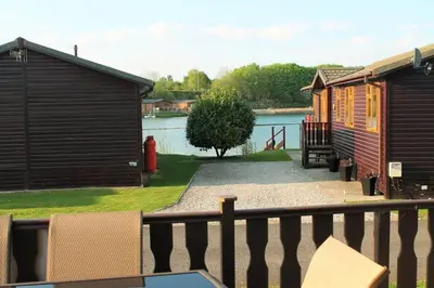 a view of a house and a lake at Luxury 3 bedroom lodge with free in lodge wifi in Carnforth