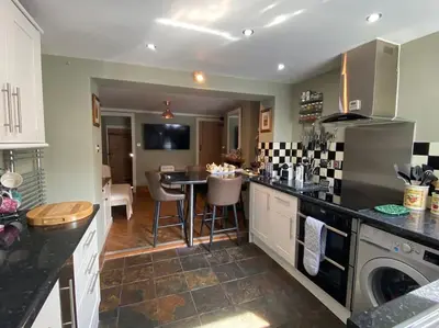 a kitchen with a table and a dining room at Outskirts of Ulverston, entire Cottage - sleeps 4 in Ulverston