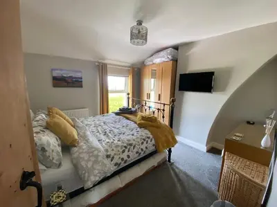 a bedroom with a bed and a television in it at Outskirts of Ulverston, entire Cottage - sleeps 4 in Ulverston