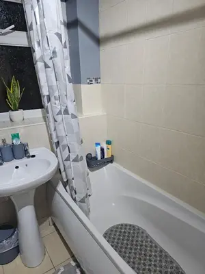 a bathroom with a sink and a toilet and a tub at Your Happy Place-2 Bedroom House in Liverpool