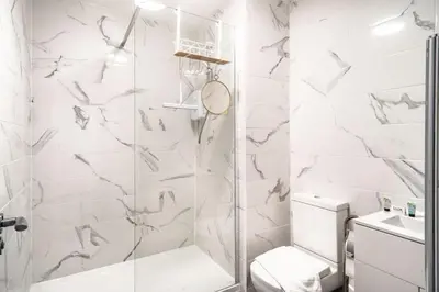 a white bathroom with a shower and a toilet at Modern 2 Bed Apartment in Waterloo Liverpool in Liverpool