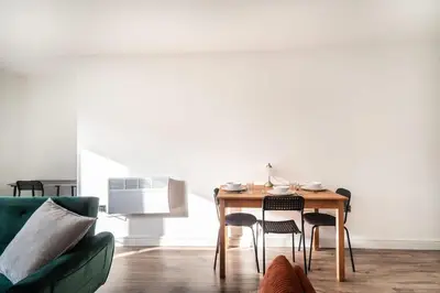 a living room with a table with chairs and a couch at Modern 2 Bed Apartment in Waterloo Liverpool in Liverpool
