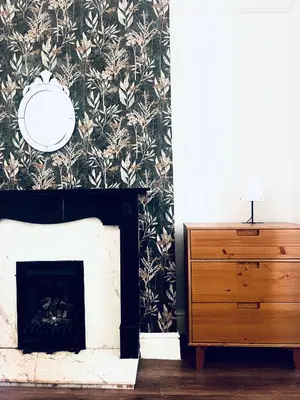 a living room with a fireplace and a dresser at Valley Road, Anfield LFC in Liverpool