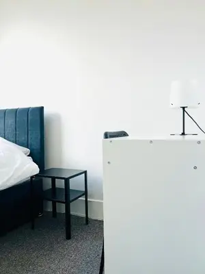 a room with a bed and a table next to a bed at Valley Road, Anfield LFC in Liverpool