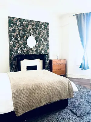 a bedroom with a bed and a fireplace at Valley Road, Anfield LFC in Liverpool