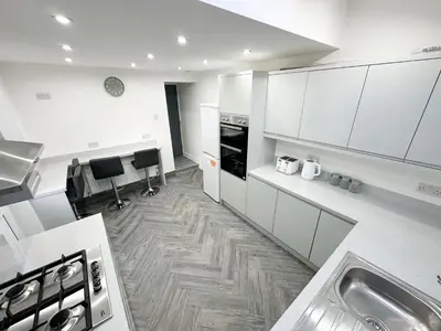 a kitchen with white cabinets and a counter top at Central Location Liverpool, Modern Home, 4 BR, Sleeps 9, Free Parking in Liverpool