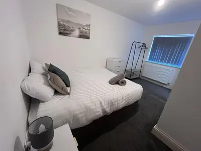 a bedroom with a bed with white sheets and pillows at Riverside by Teil Luxurious one bed Apartment in Preston